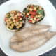 Fried mackerel fillet is plated alongside mushrooms