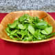 Rinse the baby spinach and add it to the salad bowl.