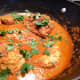 Chicken simmering in tikka masala sauce