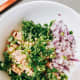 In a bowl, combine the tuna, chopped onion, serrano pepper, red onion, salt, pepper, lime juice, and mayonnaise. 