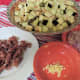 Finely chopped prosciutto along with other prepped items.