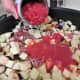 Add the tomatoes to the mixture in the pan.