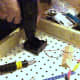 After components were laid out for adequate spacing, the battery comparment, the knife switch and the screw-base lamp holders were screwed onto the peg board using a drill to pre-make holes and then a screw driver to screw in the screws.