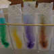 Place strips in a container filled with water so that the dots of marker do not touch the water and watch the colour move up the paper towel.