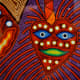 Huichol brightly embroidered art piece.