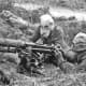 Machine gun team in action during a gas attack on the Western Front 1916.
