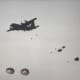 Paratroopers jumping from a C-130 during a mass parachute drop.