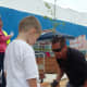 Eric Standridge with his son working on laying brick