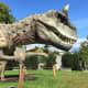 Carnotaurus with Amargasaurus in the background