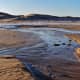First melt of Lake Michigan ices shelf creates streams on the beach.