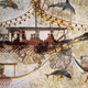 The Minoan fleet, with celebrants in gaily-decked boats and dolphins frolicking around them. Minoan art takes great delight in the natural world; flowers, dolphins, birds, even octopi seem to dance.