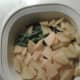 Cooked, drained potato slices are hanging out with the cooked green beans waiting for the completion of the dish.