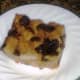 A slice of bread pudding ready to be garnished or eaten as is. 