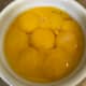 8 egg yolks are whisked into the hot cream  base. They bring richness and depth of flavor and serve to thicken the gorgeous custard.