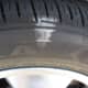 The outer front tire has more weight on it as the car leans and, therefore, uses the entire tread width, even when overinflated by 5 psi.