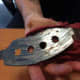This brake pad is prematurely worn because of frozen or rusted caliper slide pins. 