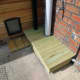 Decking fitted to base, last peice locking platform in place around the rain water down pipe.