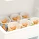 Place the cups in the freezer. The freezer door works great for this.