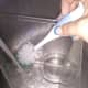 Use a bottle brush to clean it.