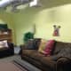 Living room space at shelter aids in helping dogs adapt to a home environment while waiting to be adopted