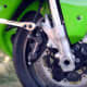 Loosening the first of the two bolts holding the caliper to the bike