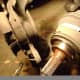 N. Pry dust shield (A) off axle shaft (B)