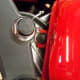 Remove the front gas tank bolt (circled in red).