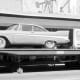 "Suddenly It's 2007" reads the sign beside the car.