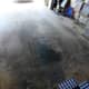 This garage floor has a large oil spot that was covered with scrap plywood before laying the awning down. Don't set your new awning in a puddle of oil!