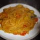 Pasta with courgette, onion and tomato sauce.