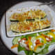 Stuffed courgette with feta cheese gratin and salad.