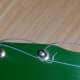 Two tuning pegs that have been completely loosened.