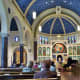View from the back looking towards the altar inside of All Saints Catholic Church 
