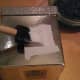 Use glue or Mod Podge to attach to the box.