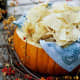 Dips or chips can be served in a pumpkin when hosting a party.