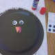 Glue on wiggly eyes, beak, and gobbler on the small plate to create the turkey face.