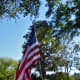 U.S. flags on poles in front yards