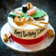 A birthday cake decorated with a theme of Japanese food.