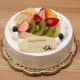 An elegant cake topped with fruit.