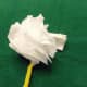 8. Tissue paper flowe with a pipe cleaner stem. This image shows the tissue fluffed on one side.