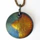 Fine silver PMC lentil pendant with 24k gold foil keum-boo and iridescent LOS patina. Front textured with a tear-away texture made from collaged images.