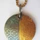 Back of fine silver PMC lentil pendant with 24k gold keum-boo, textured with two tear-away textures taped side-by-side.