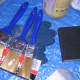 Tools: paintbrushes, sanding block, and gloves