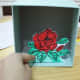 The rose is attached to my diorama with the tab I added.