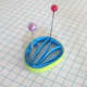 A fan-shaped husking with a different colour paper strip around it.