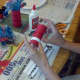 Glue 2 white strips of paper to top and bottom of toilet paper roll.