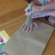 Outline your child's handprints on a brown paper bag.