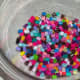 Perler beads in the oven-safe bowl.
