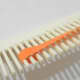 Wrap quilling paper around three prongs of the comb.