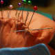 3. Using a matching thread color, whip stitch tightly along the edge, removing pins as needed.